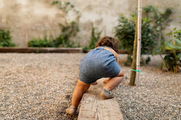 Babe climbing on a backyard bench