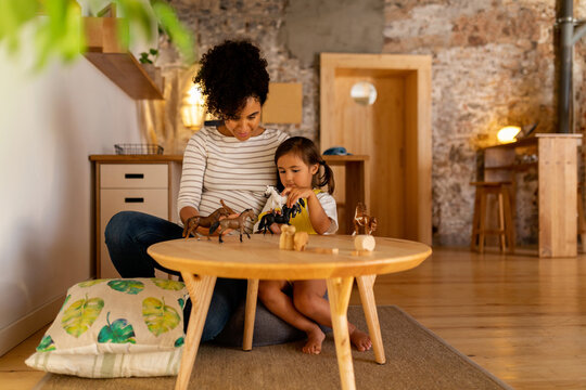 Babysitter and child playing at home
