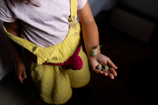little girl holding snails