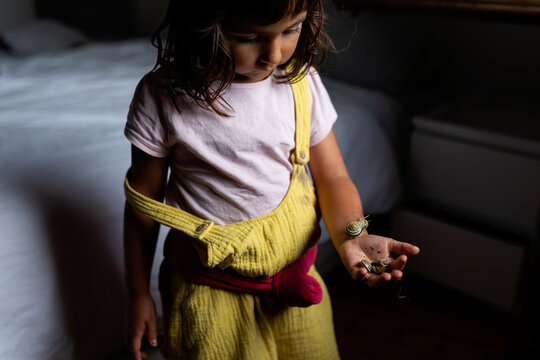 little girl holding snails