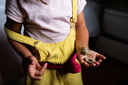 little girl holding snails