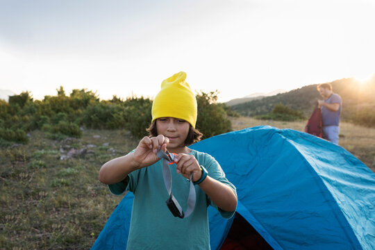 Young boy installing tent 