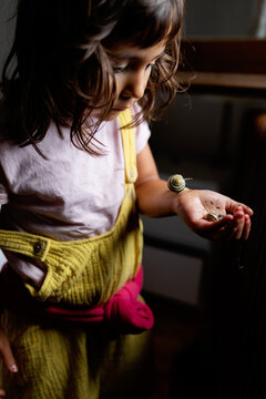 little girl holding snails