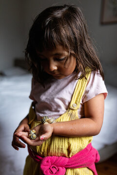 little girl holding snails
