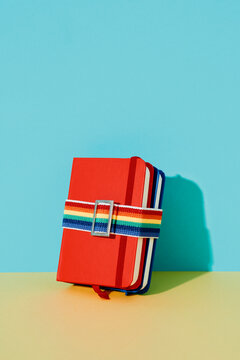 two notebooks tied with a rainbow band