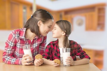 Healthy Breakfast. Cute Little Girl And Her Smiling mother Eating Homemade Cookies