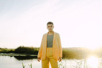 Man in suit standing alone in nature