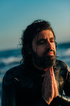 Portrait of a surfer with namaste gesture
