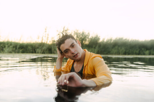 Clothed man submerged in lake water