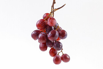 Fresh red or purple grapes fruit isolated on white background