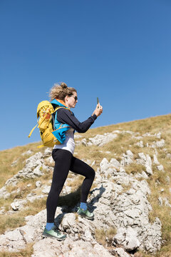 Woman Catching Phone Signal in the Mountains