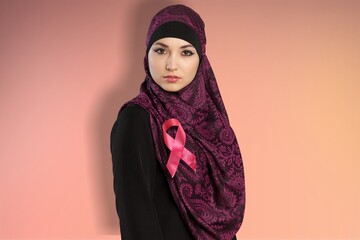 Confident portrait of a friendly Arab Muslim woman wearing a hijab and ribbon