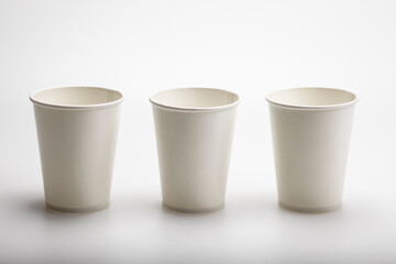 Three paper cups side by side stay on white background