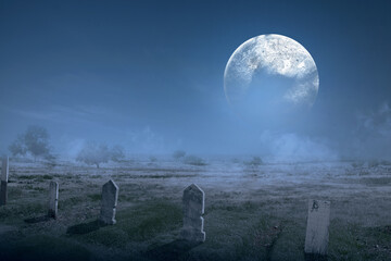 Tombstones on the graveyard with full moon background