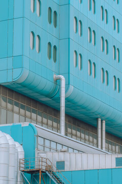 Blue building facade with pipes