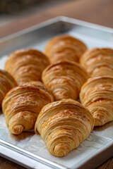 Close up of freshly baked plain Croissant. Homemade French butter croissants.