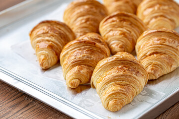 Close up of freshly baked plain Croissant. Homemade French butter croissants.