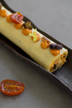 Cold cannelloni with escarole, cod and romesco salad