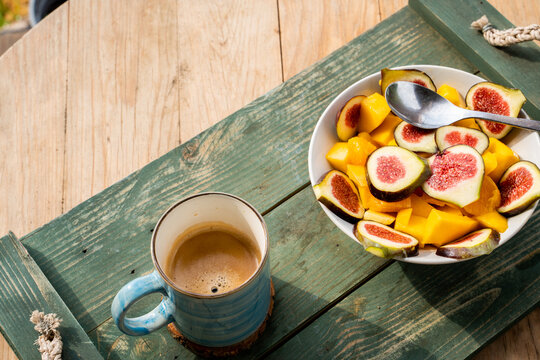 Above shot of fruit salad bowl and coffe cup on table