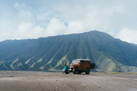 Woman standing near SUV, Bromo volcano, Java 