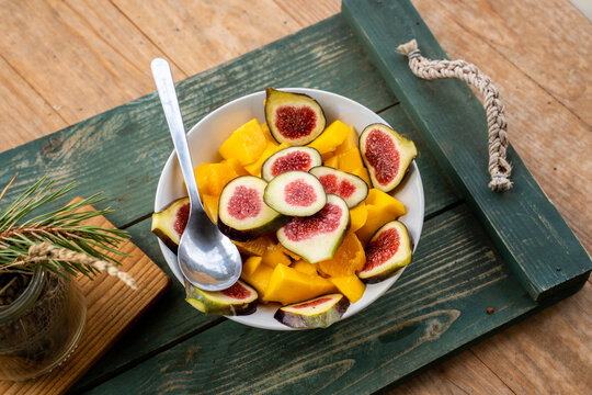 Above angle of yummy fruit salad with figs and mango