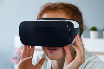 Amazed child in VR goggles
