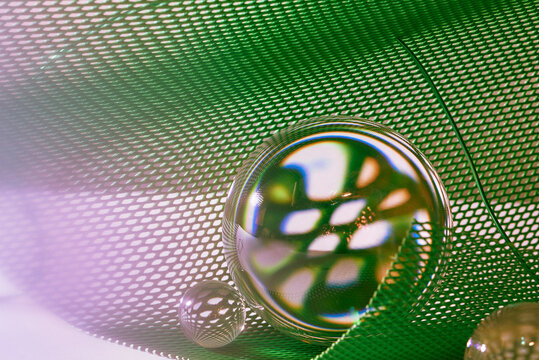 crystal ball in the green plastic nets with the reflection