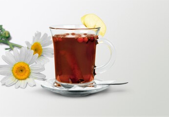 Chamomile tea in a mug with natural small chamomile flowers