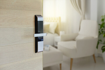Digital Door handle or Electronics knob  for access to room security, Door wooden half opening through interior living room background, selective focus