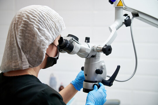 Dentists during a dental intervention using microscope