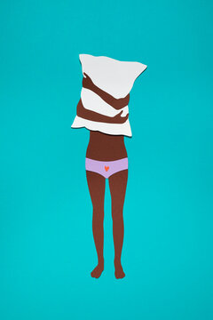 Female adolescent hiding behind a pillow