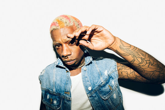 Punk man with tattoos and colorful hair style 