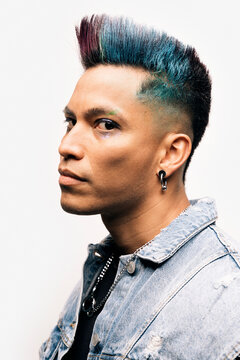 Serious man with a punk style looking at camera