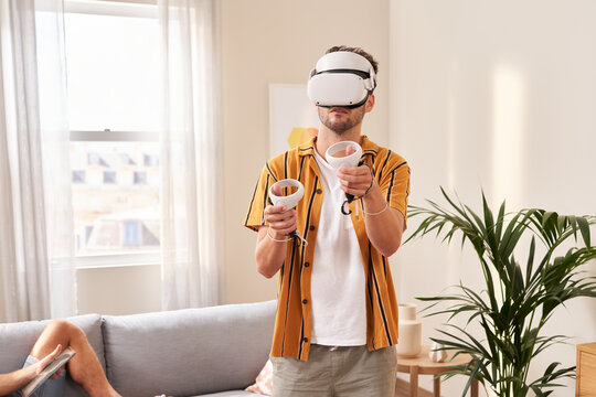 Concentrated man in VR glasses.