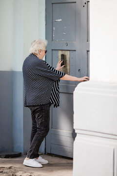 Senior woman using entry phone