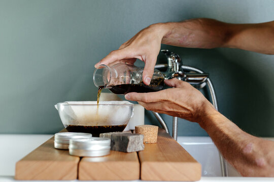 Crop man with psoriasis preparing herbal decoction 