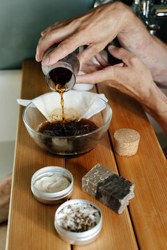 `Man with psoriasis pouring herbal decoction  for skin 