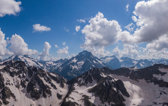 rugged mountain peak seen behind snowy range