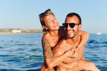 Laughing couple having fun in the ocean