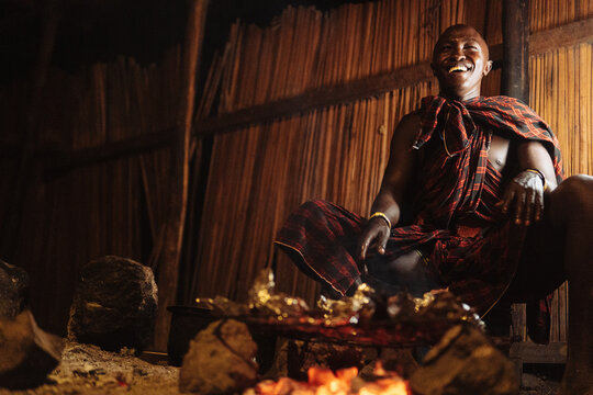 Masai man cooking.