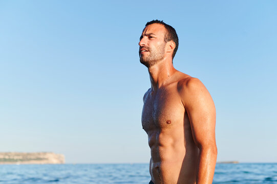 Fit man standing in the ocean