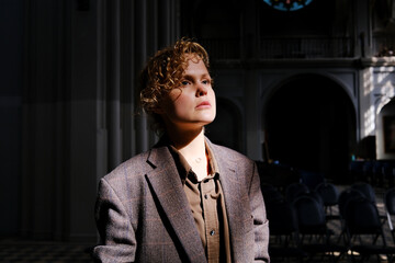 Curly girl standing in church