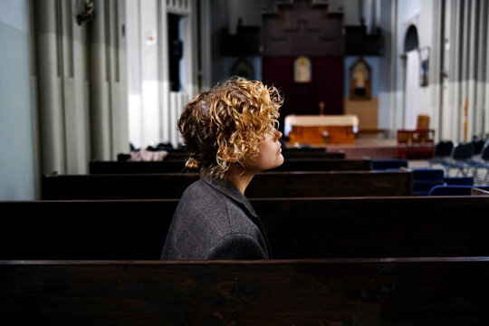 Girl sitting on pew in church