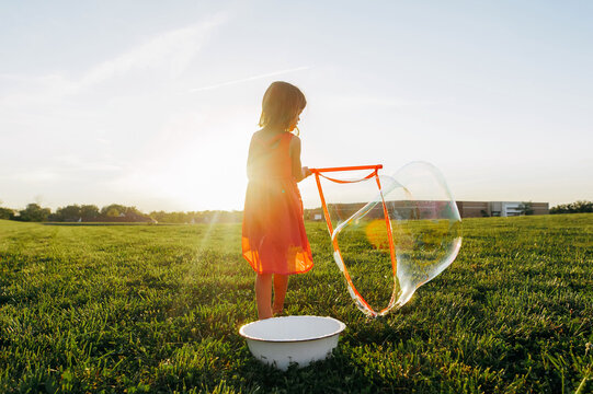 Back of a girl wearing a pink dress. 
