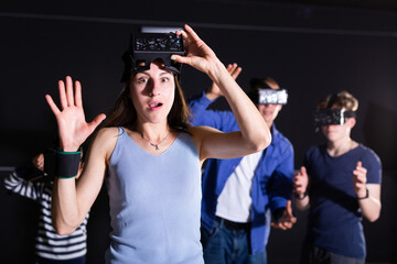 Portrait of a young woman with a very surprised look, who took off her virtual reality glasses