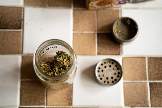 Detail of cannabis jar and grinder