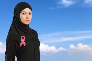 Confident portrait of a friendly Arab Muslim woman wearing a hijab and ribbon