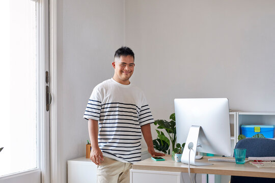 Happy man with disability at workplace