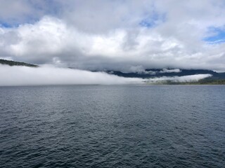Obraz premium Low clouds over the ocean on Vancouver Island. Pacific ocean near Port Renfrew in Canada