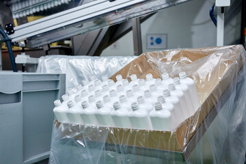Plastic bottles in container at factory